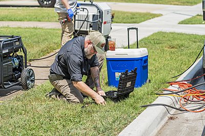 Professional plumber using diagnostic equipment for residential sewer inspection